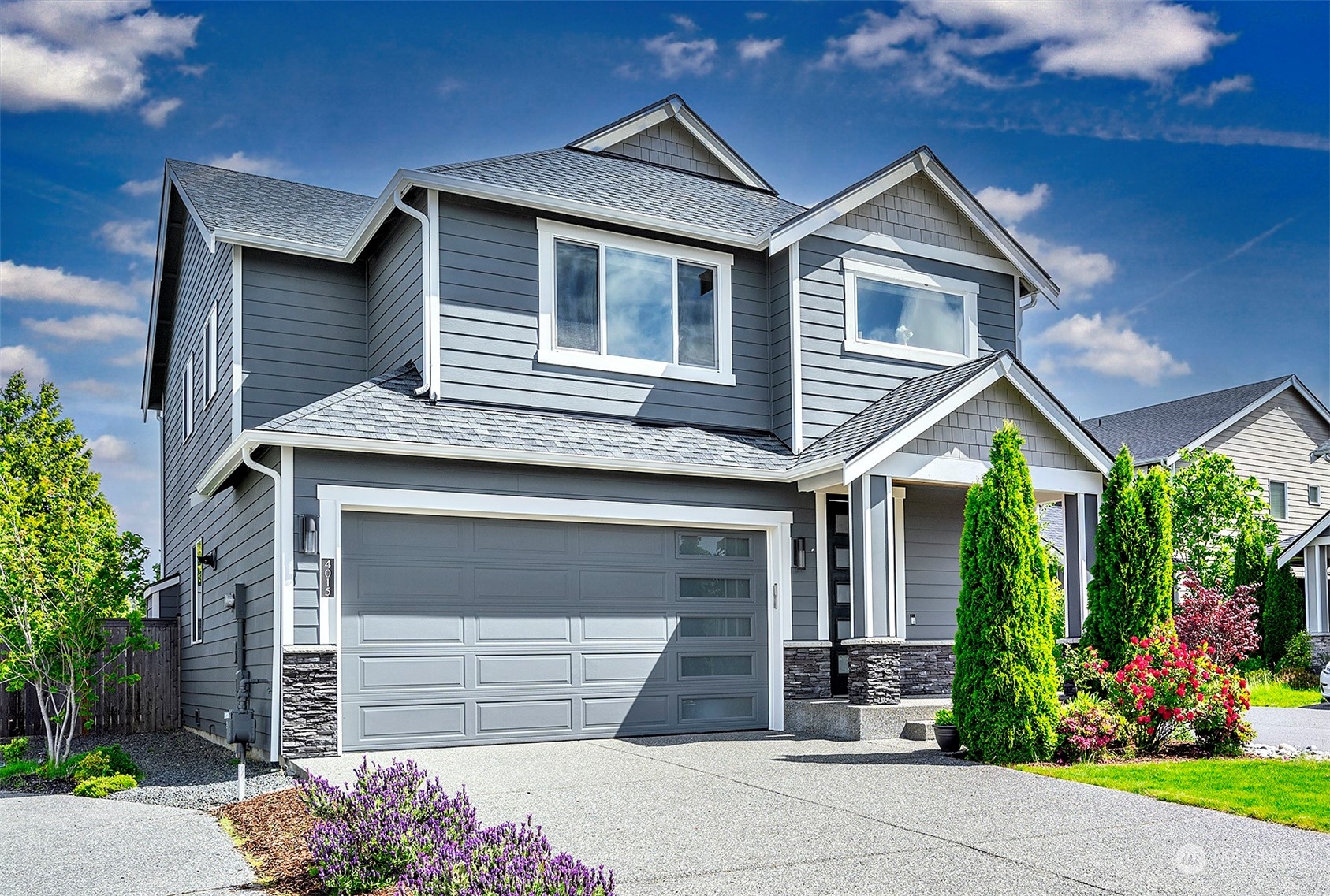 4015 147th Place Southeast Bothell, WA 98012 - Photo 2 of 31 a front view of a house with a garden