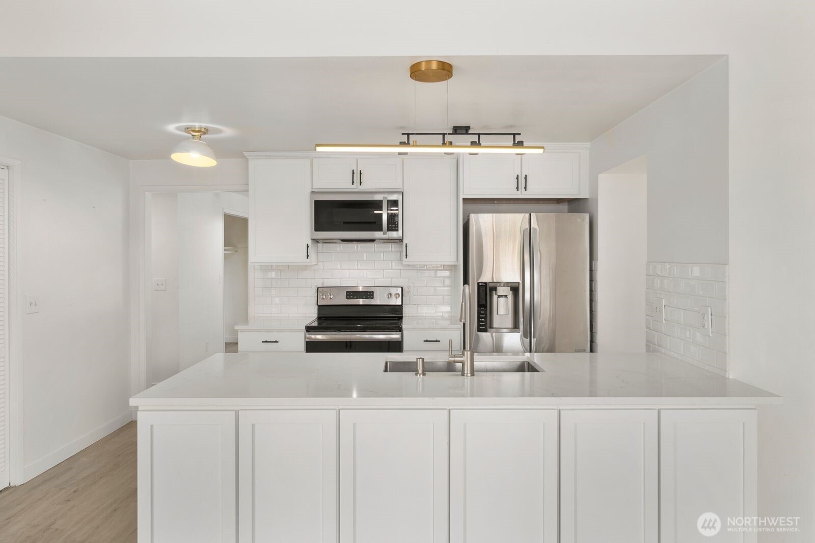 101 161st Street Southeast Bothell, WA 98012 - Photo 18 of 34 a kitchen with kitchen island white cabinets and refrigerator