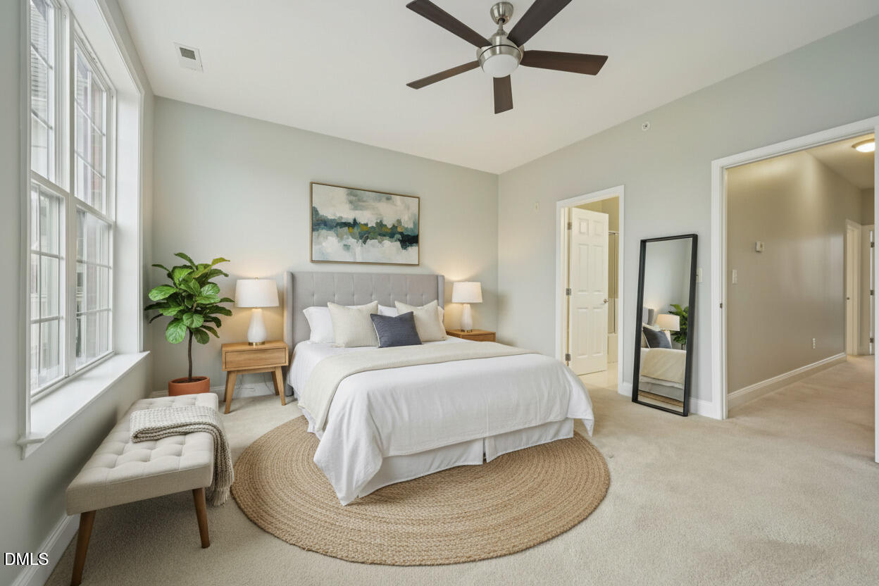10510 Sablewood Drive, Unit 113 Raleigh, NC 27617 - Photo 23 of 38 a bedroom with a bed and a chandelier