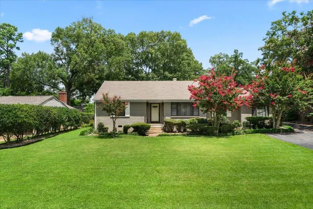 a view of a house with a yard porch and sitting area