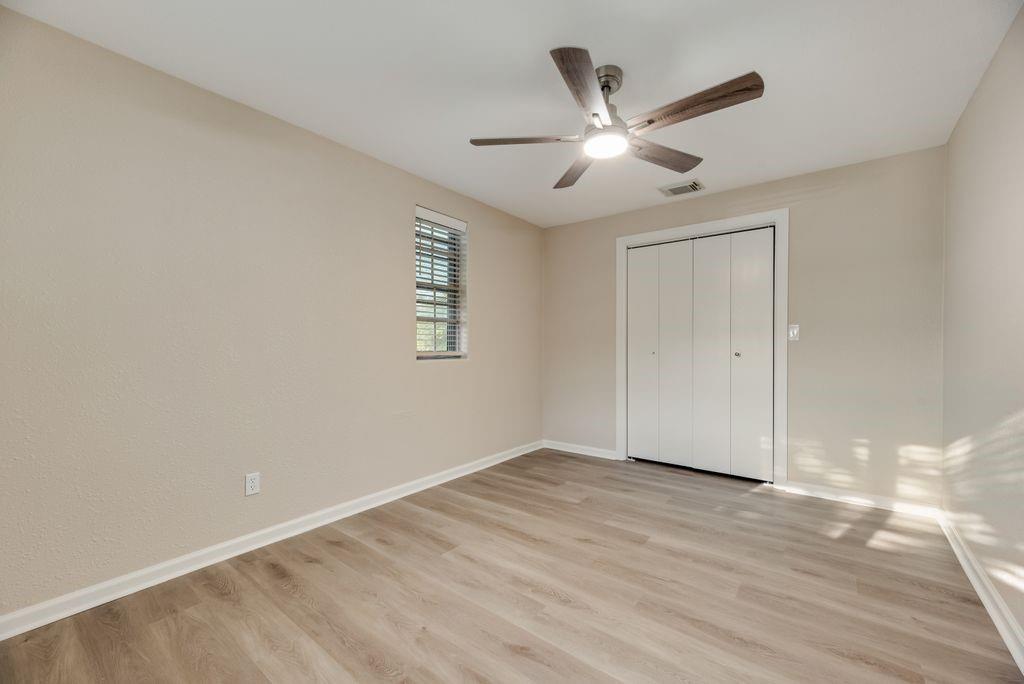 5706 Rocky Ridge Road Dallas, TX 75241 - Photo 15 of 31 a view of an empty room with wooden floor