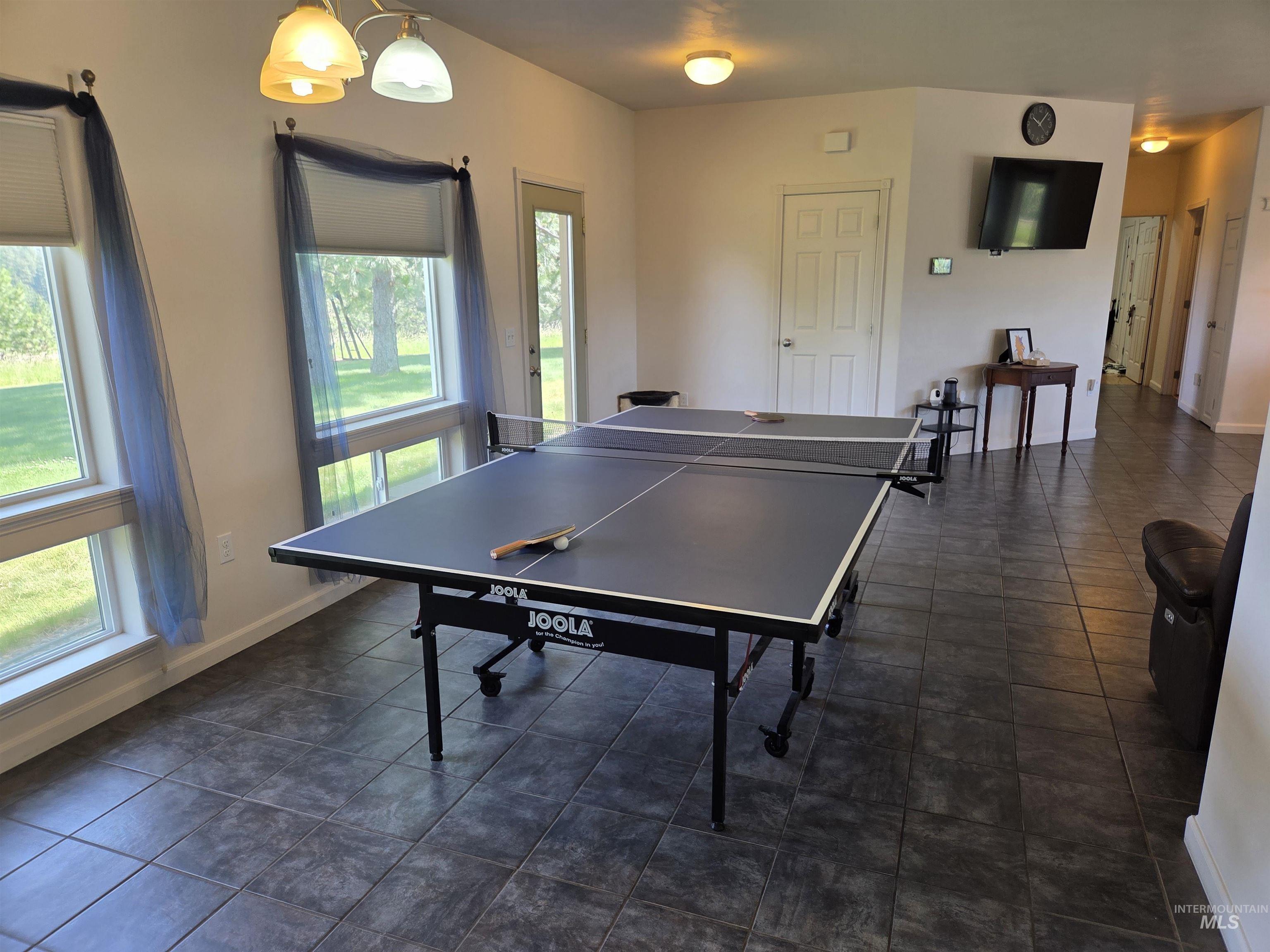 1085 Wallen Road Moscow, ID 83843 - Photo 16 of 50 Spacious room featuring large windows, a single exterior door, white interior doors, and consistent tile flooring throughout
