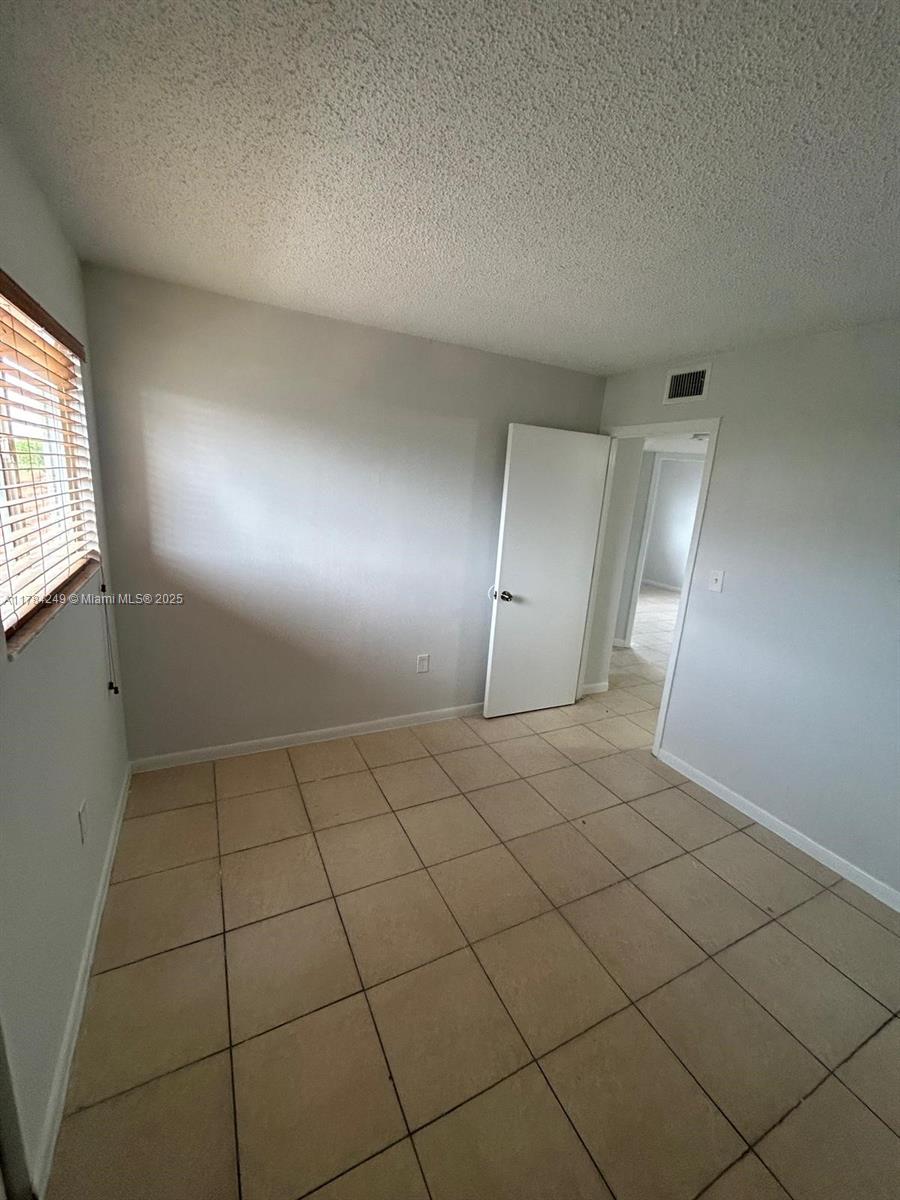 15201 Southwest 80th Street, Unit 302 Miami, FL 33193 - Photo 17 of 30 an empty room with a bathroom