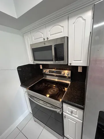 a view of an empty room and staircase