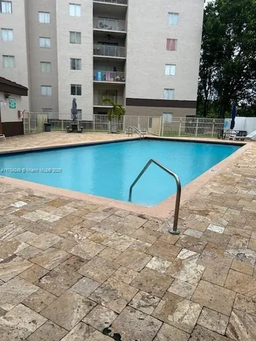 a kitchen with kitchen island a sink stove and cabinets