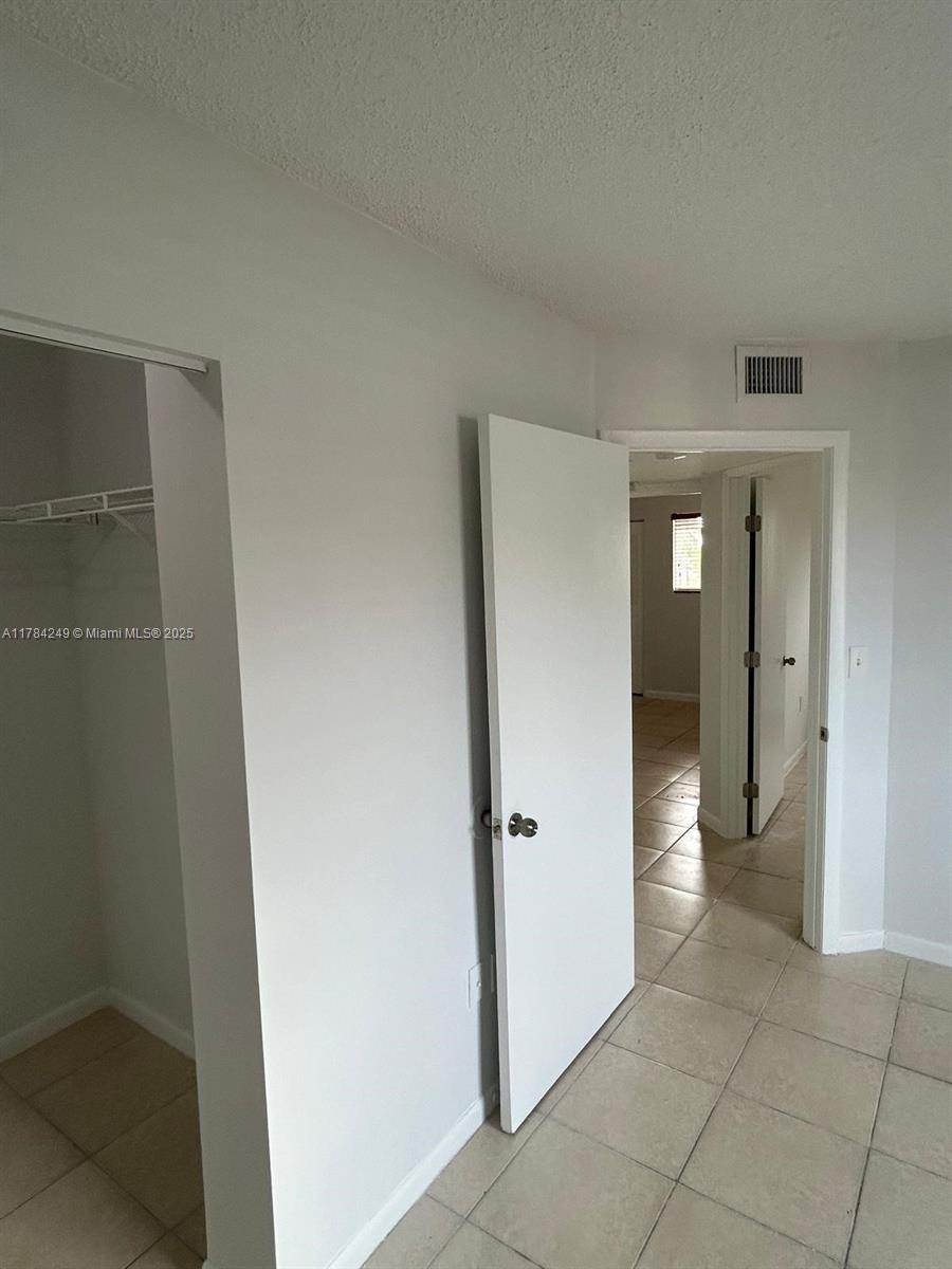 15201 Southwest 80th Street, Unit 302 Miami, FL 33193 - Photo 23 of 30 a view of a bathroom from a hallway