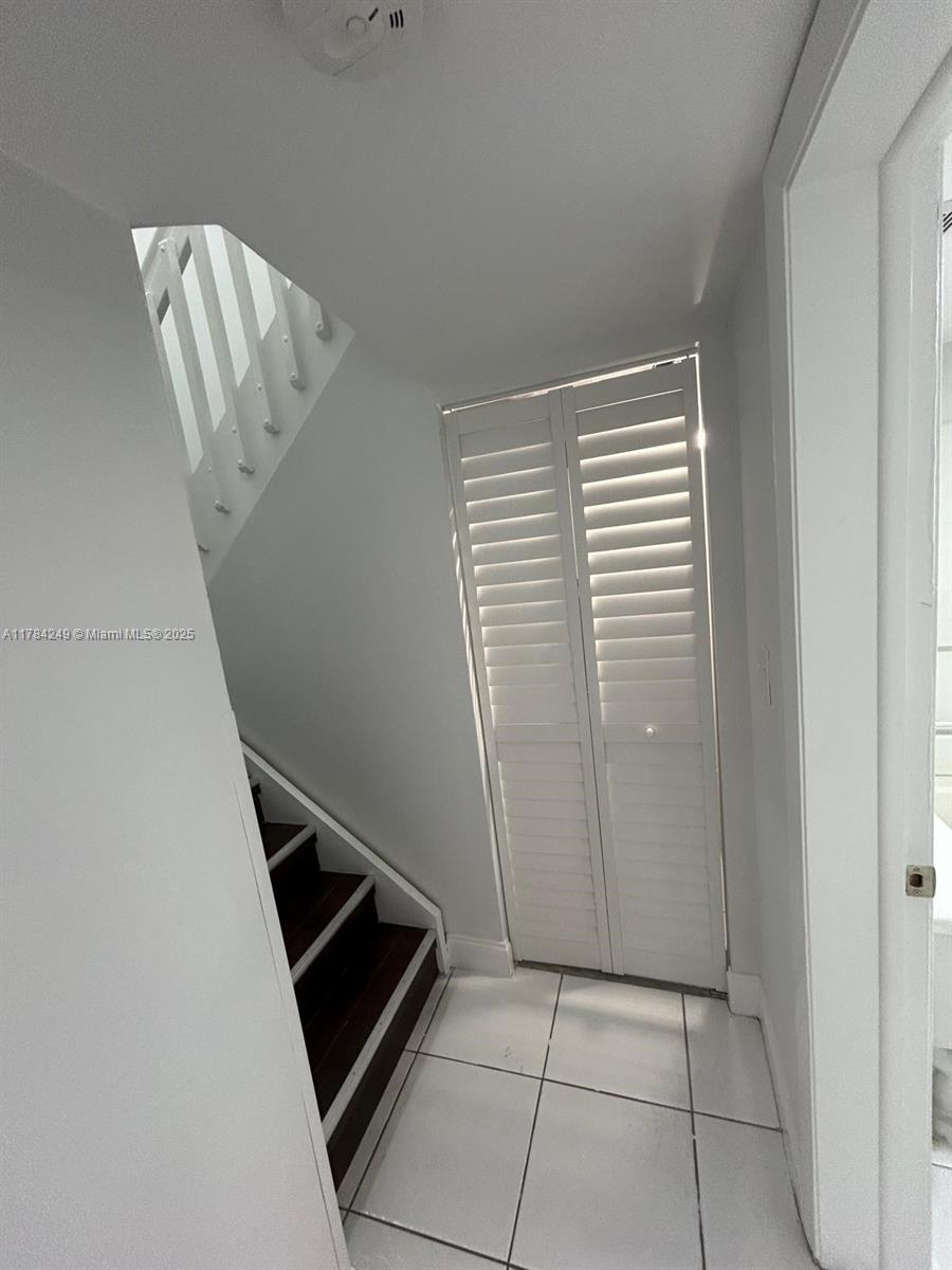 15201 Southwest 80th Street, Unit 302 Miami, FL 33193 - Photo 28 of 30 a view of an empty room with stairs