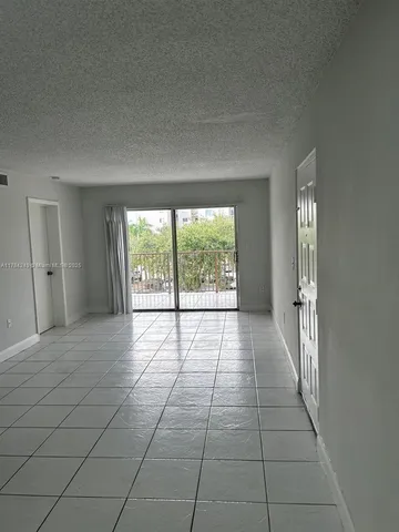 a kitchen with granite countertop a refrigerator and a stove top oven