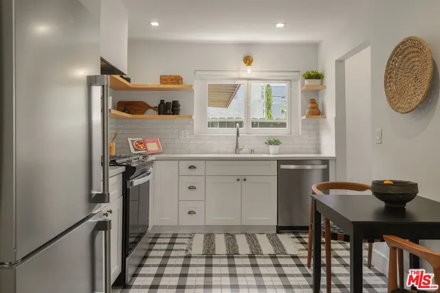 a kitchen with a sink cabinets and window