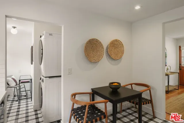 a room with a table and a chandelier