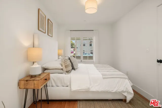 a bedroom with a bed and a lamp