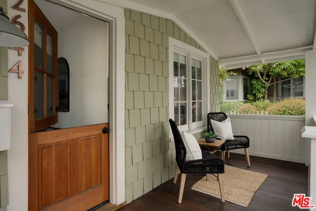 a view of a room that has a couch and a refrigerator in it