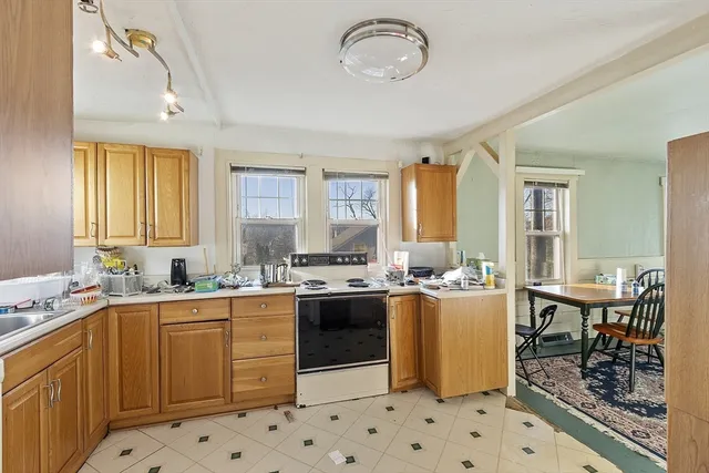 a kitchen with a sink a stove a refrigerator and cabinets
