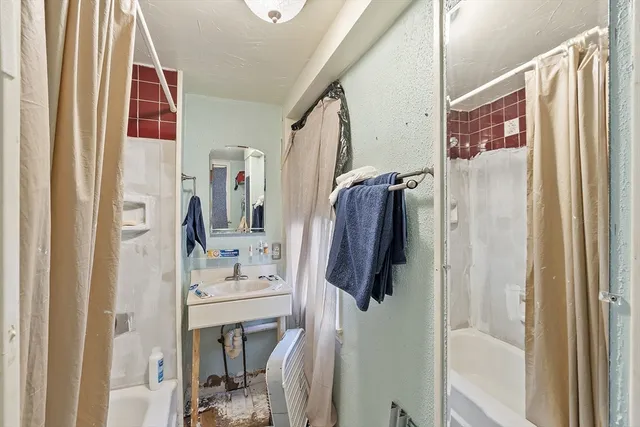 a bathroom with a bathtub and a shower