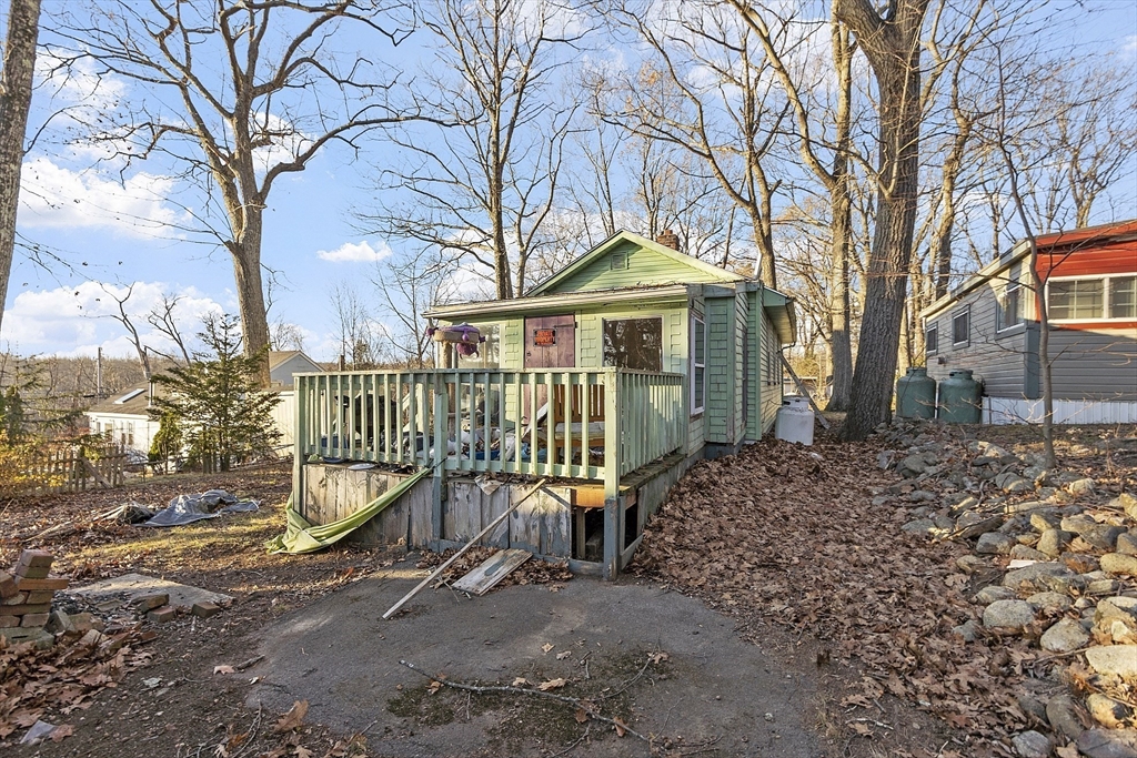 2 Kosta Avenue Rutland, MA 01543 - Photo 31 of 34 a view of a house with a wooden deck next to a yard