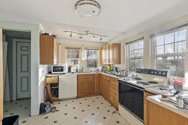 a kitchen with a sink stove and cabinets