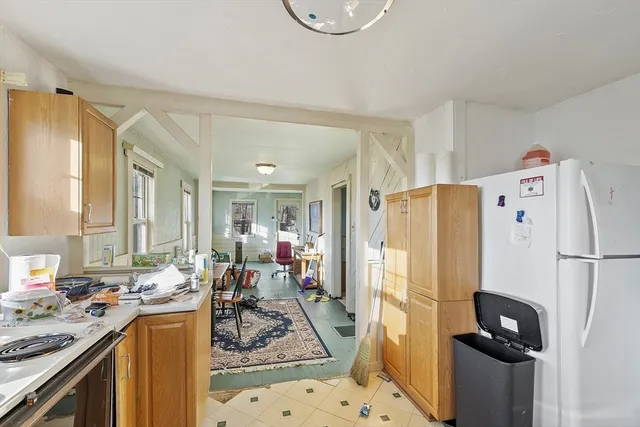 a kitchen with a refrigerator a stove top oven a sink and dishwasher