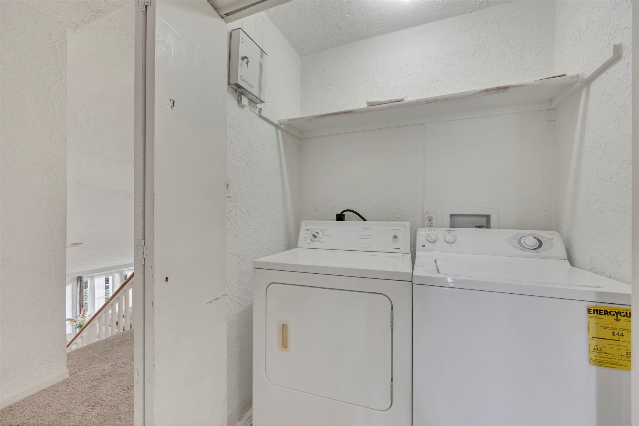 15619 Beechnut Street Houston, TX 77083 - Photo 16 of 29 Convenient upstairs laundry space with shelving—keeping chores efficient and organized.