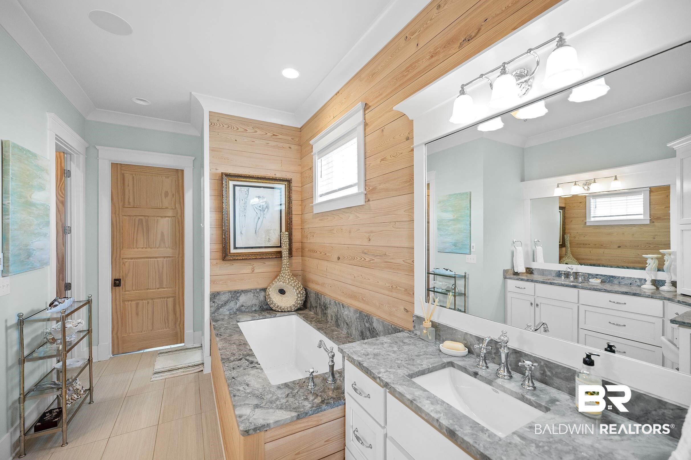 33186 Marlin Key Drive Orange Beach, AL 36561 - Photo 52 of 87 Full bath with crown molding, wooden walls, a bath, vanity, and light tile patterned flooring