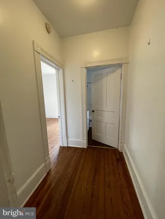 a view of a room with wooden floor and a sink
