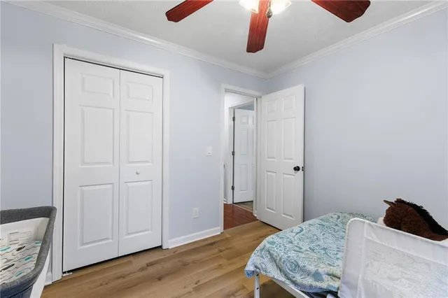 a bedroom with a bed and wooden floor