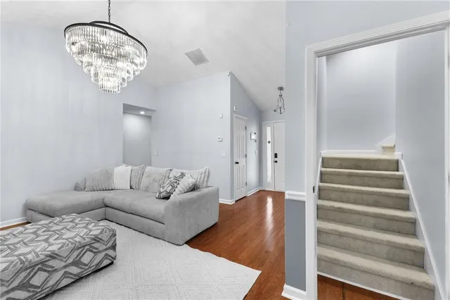 a living room with furniture and a chandelier