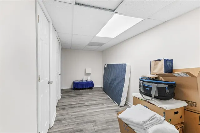 a view of a workspace with furniture and wooden floor