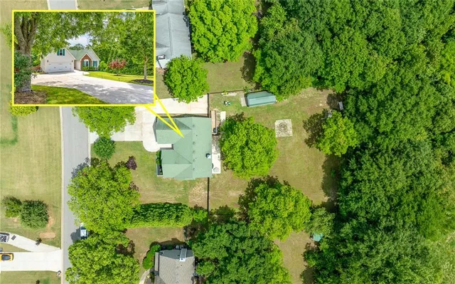 an aerial view of a house with a yard
