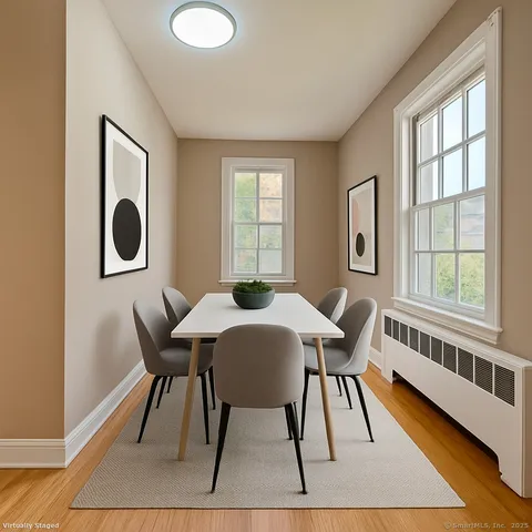 a view of a dining room with furniture and wooden floor