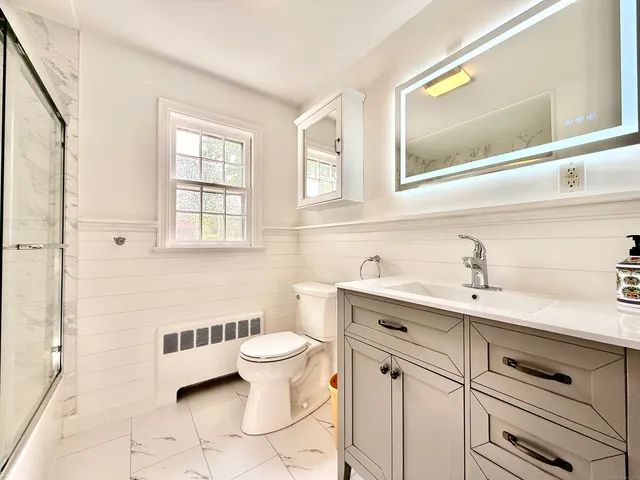 a bathroom with a sink toilet and shower