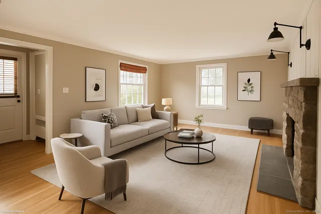 a living room with furniture a flat screen tv and a window