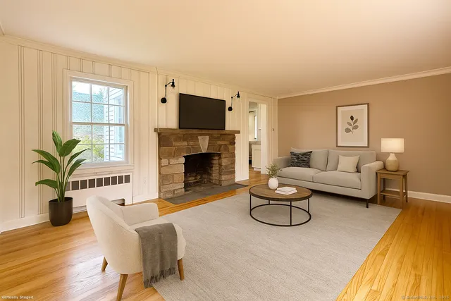 a living room with furniture a fireplace and a potted plant