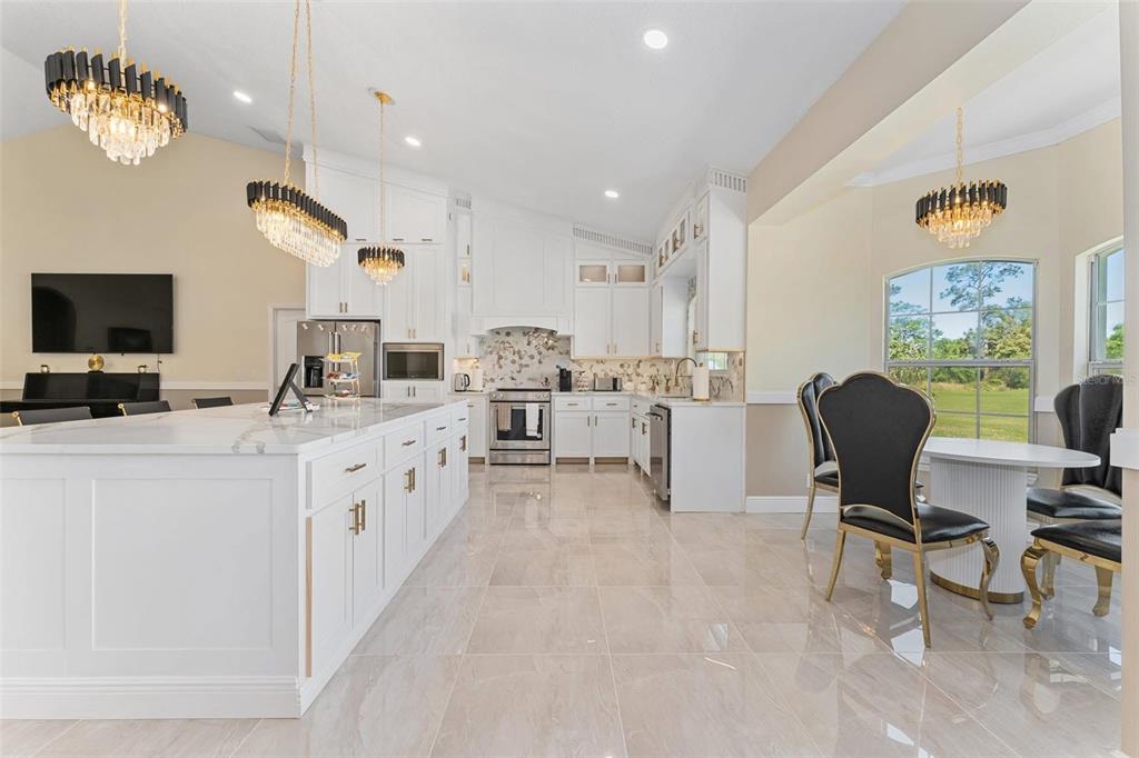 2832 Rodeo Drive Kissimmee, FL 34746 - Photo 12 of 46 a kitchen with stainless steel appliances kitchen island granite countertop a sink and cabinets