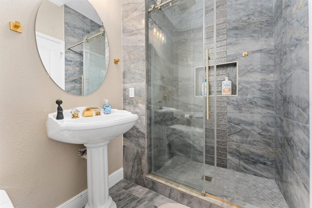 2832 Rodeo Drive Kissimmee, FL 34746 - Photo 16 of 46 a bathroom with a sink a mirror and shower