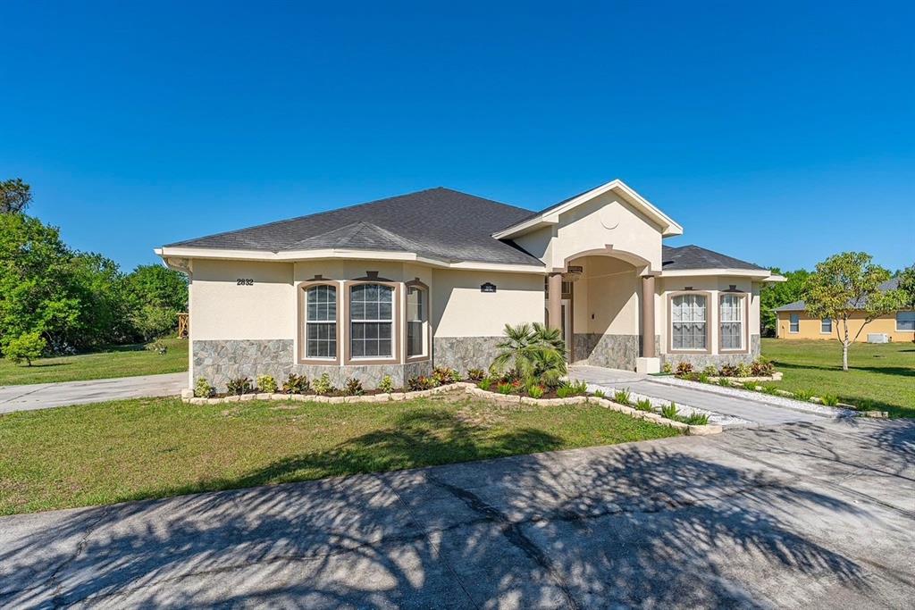 2832 Rodeo Drive Kissimmee, FL 34746 - Photo 2 of 46 a front view of a house with a yard