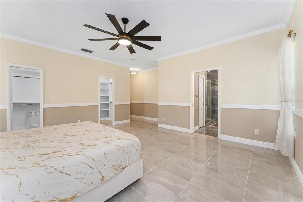 2832 Rodeo Drive Kissimmee, FL 34746 - Photo 24 of 46 a spacious bedroom with a bed and a ceiling fan