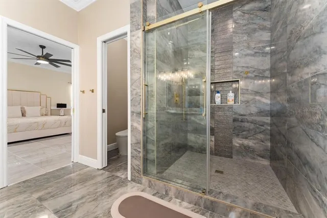 a bathroom with a shower and a sink mirror