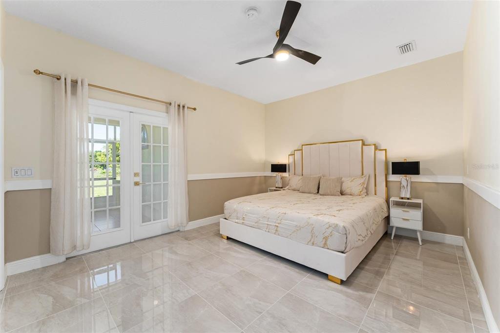 2832 Rodeo Drive Kissimmee, FL 34746 - Photo 28 of 46 a spacious bedroom with a bed and a cabinets