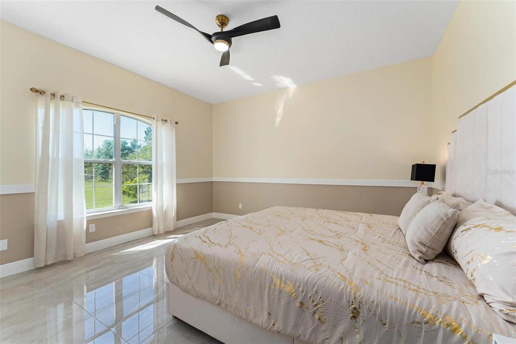 2832 Rodeo Drive Kissimmee, FL 34746 - Photo 30 of 46 a bedroom with a large bed and a large window