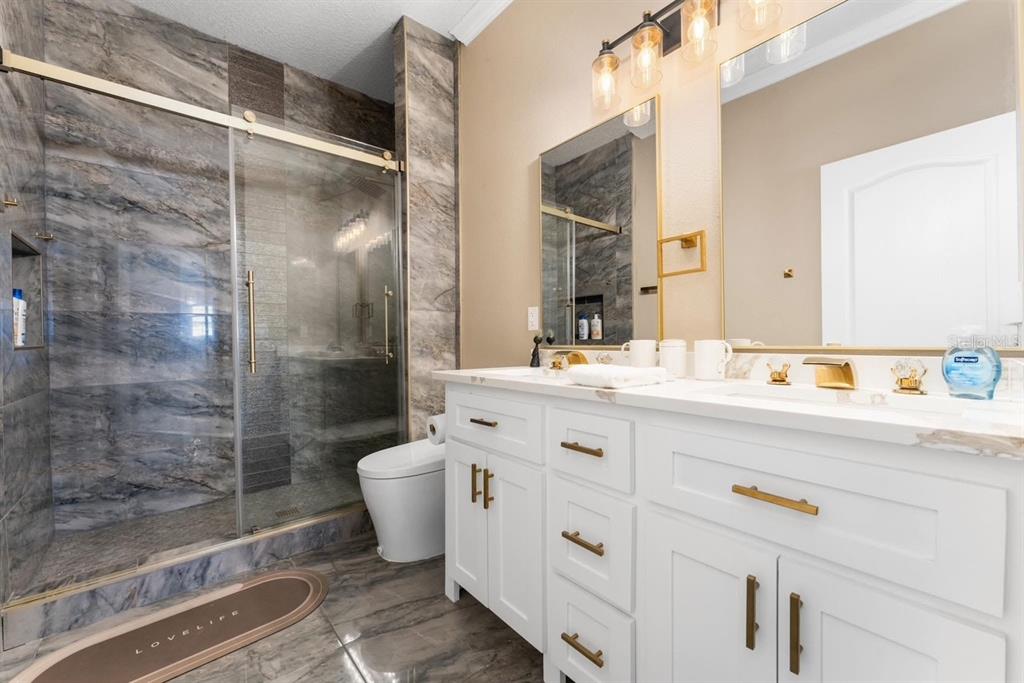 2832 Rodeo Drive Kissimmee, FL 34746 - Photo 33 of 46 a bathroom with a shower sink vanity and toilet