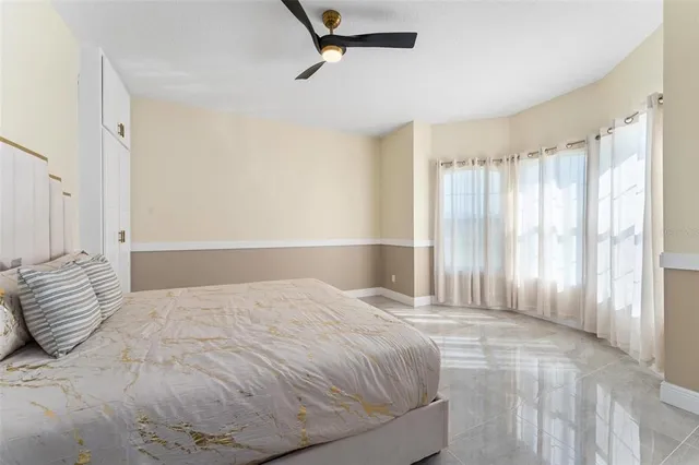 a bedroom with a large bed and a large window