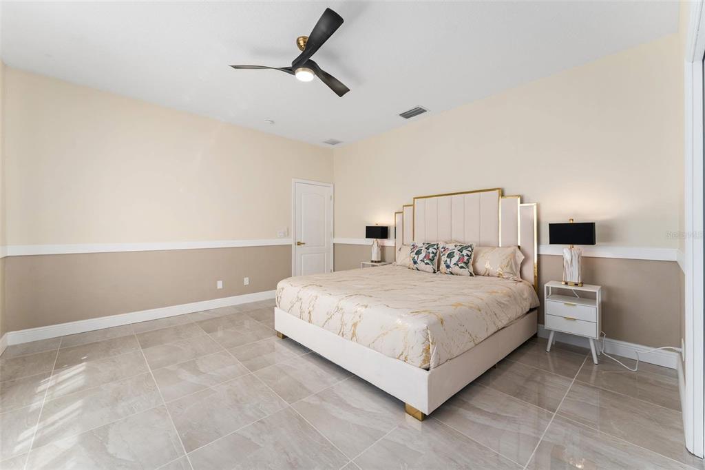 2832 Rodeo Drive Kissimmee, FL 34746 - Photo 35 of 46 a bedroom with a bed and a night stand