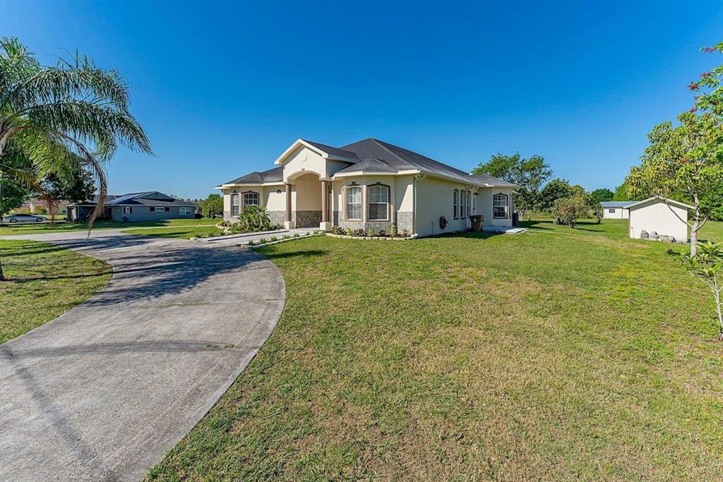 2832 Rodeo Drive Kissimmee, FL 34746 - Photo 5 of 46 a view of a house with a yard