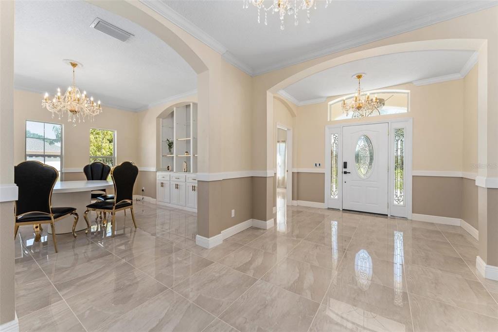 2832 Rodeo Drive Kissimmee, FL 34746 - Photo 6 of 46 a living room with furniture and a chandelier