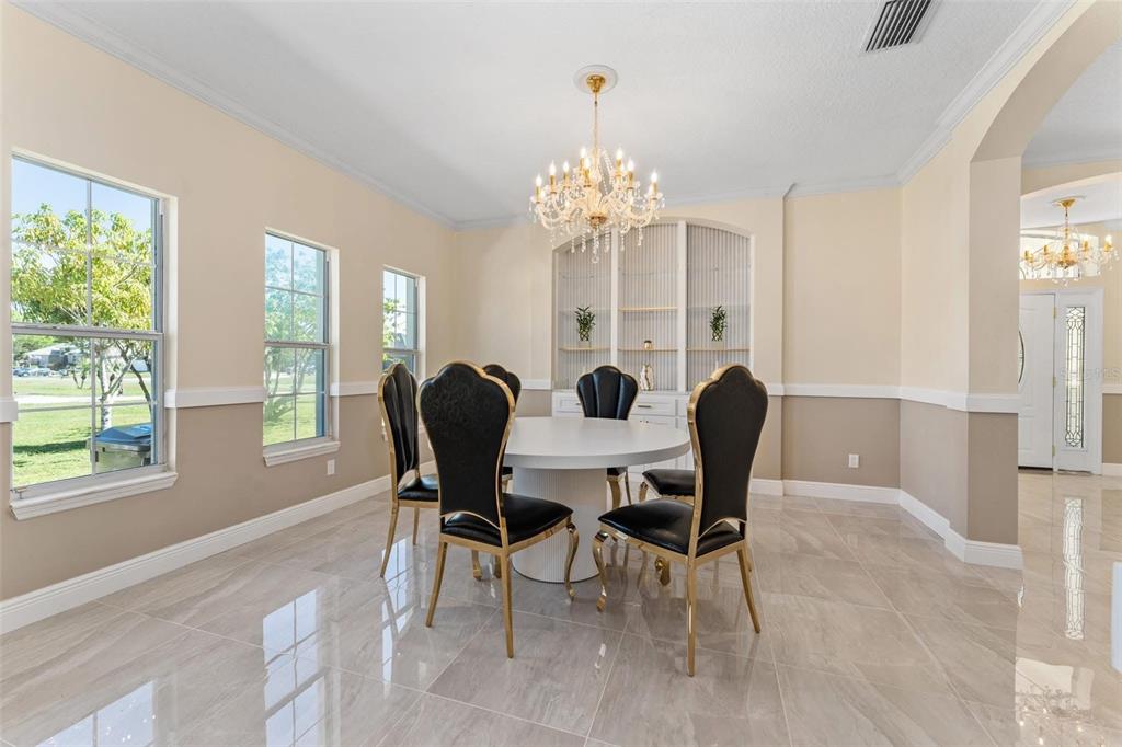 2832 Rodeo Drive Kissimmee, FL 34746 - Photo 7 of 46 a view of a dining room with furniture and chandelier