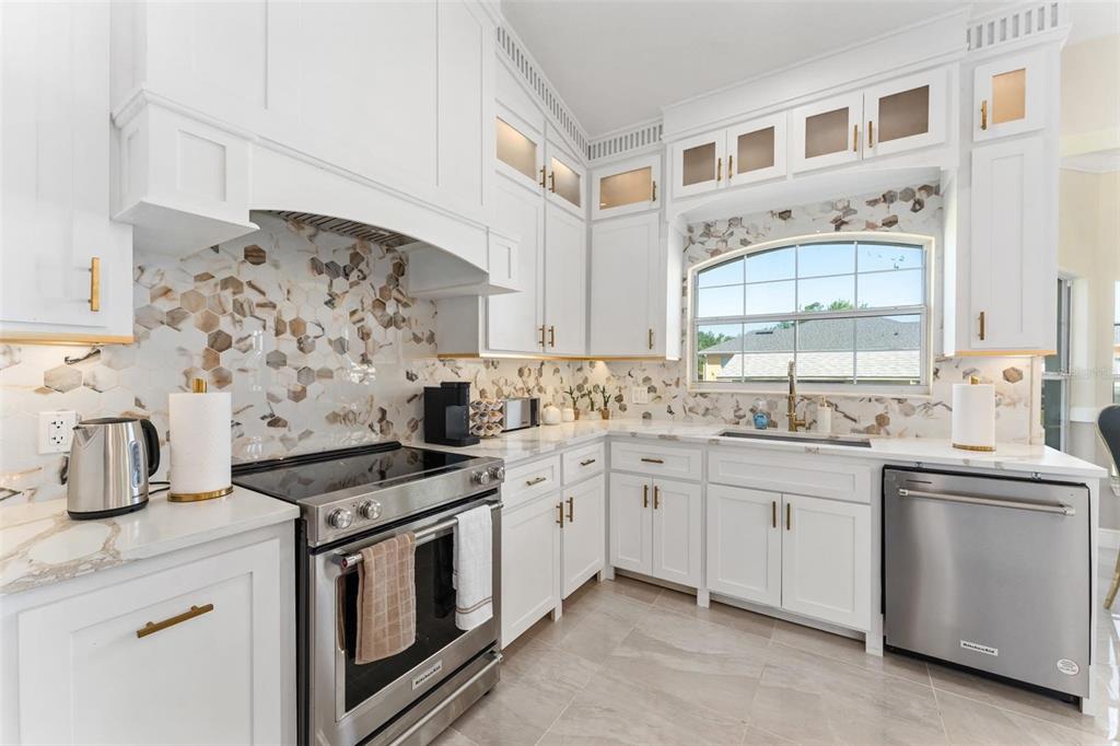 2832 Rodeo Drive Kissimmee, FL 34746 - Photo 9 of 46 a kitchen with stainless steel appliances granite countertop a sink stove and cabinets