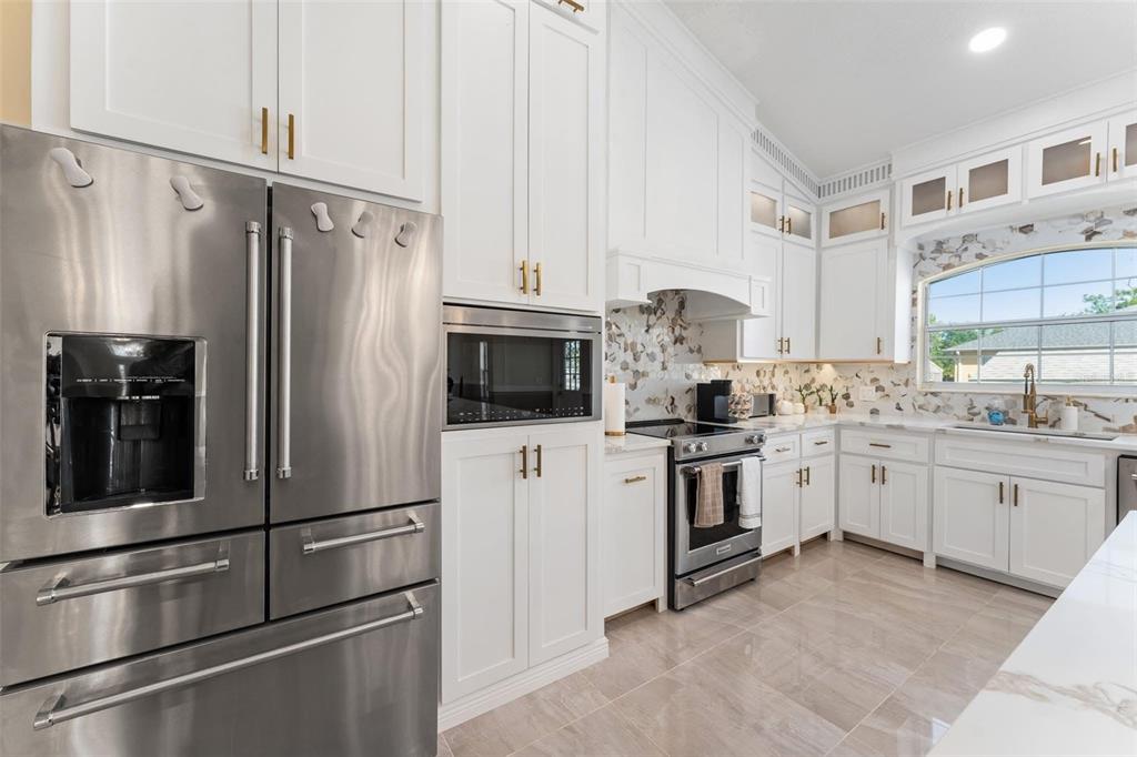 2832 Rodeo Drive Kissimmee, FL 34746 - Photo 10 of 46 a kitchen with white cabinets and stainless steel appliances