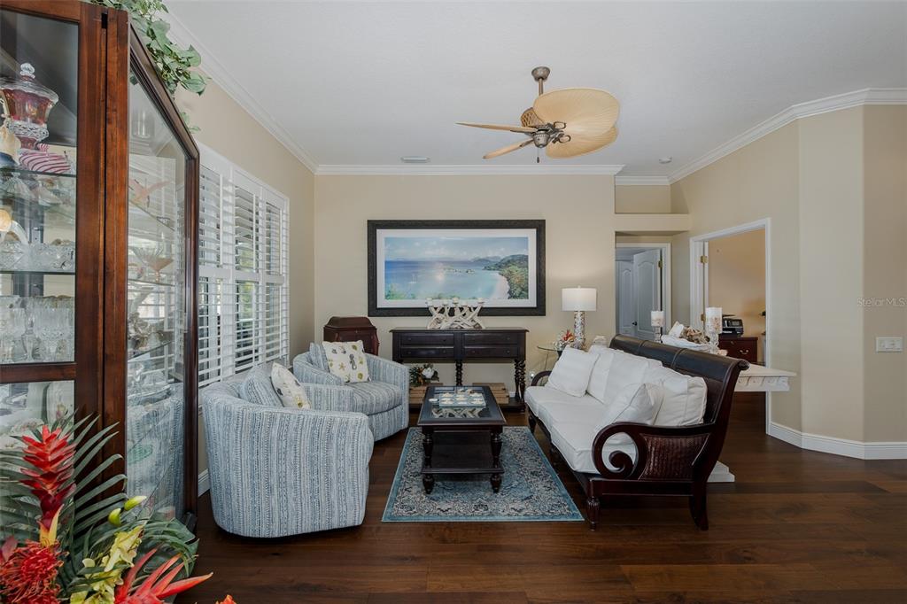 2928 Waters Edge Road Palm Harbor, FL 34685 - Photo 14 of 52 a living room with furniture and a chandelier