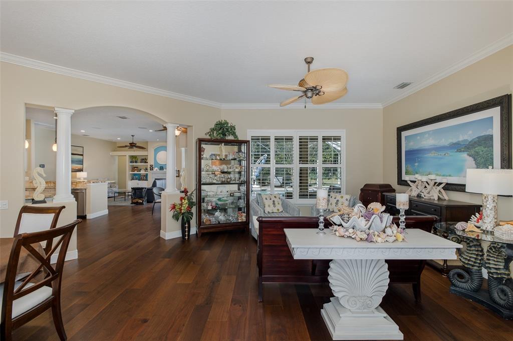 2928 Waters Edge Road Palm Harbor, FL 34685 - Photo 15 of 52 a view of a dining room with furniture and wooden floor