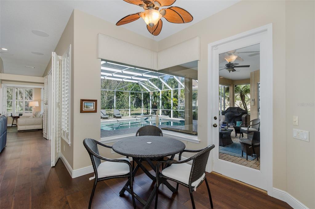 2928 Waters Edge Road Palm Harbor, FL 34685 - Photo 16 of 52 a view of a dining room with furniture wooden floor and a chandelier